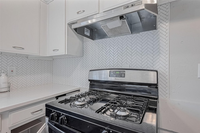 kitchen featuring range with gas cooktop, backsplash, white cabinetry, and under cabinet range hood