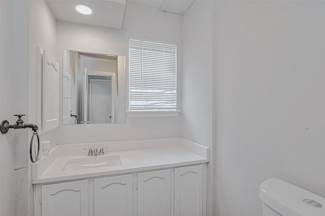 half bath featuring toilet and vanity