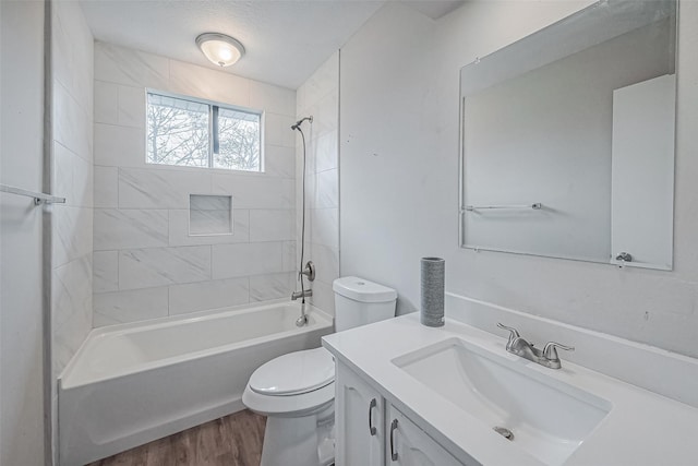 full bathroom with toilet, vanity, wood finished floors, and  shower combination