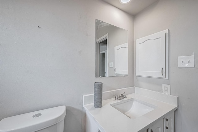 bathroom featuring toilet and vanity