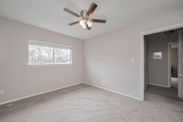 unfurnished room featuring carpet floors, ceiling fan, and baseboards