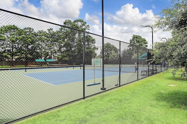 view of sport court with fence