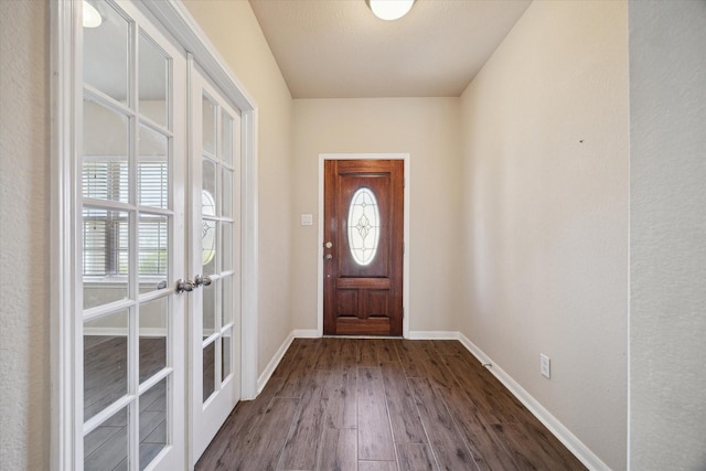 foyer entrance featuring french doors, dark wood-style flooring, and baseboards