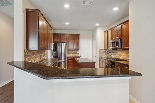 kitchen featuring baseboards, visible vents, and appliances with stainless steel finishes