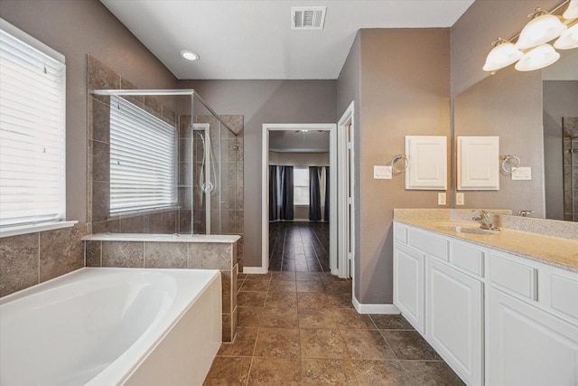 full bath featuring vanity, a bath, visible vents, and a stall shower