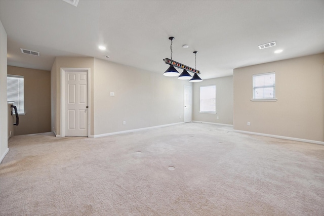 empty room with recessed lighting, baseboards, visible vents, and light carpet