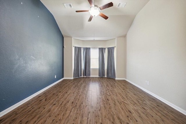 spare room with a ceiling fan, wood finished floors, visible vents, and baseboards