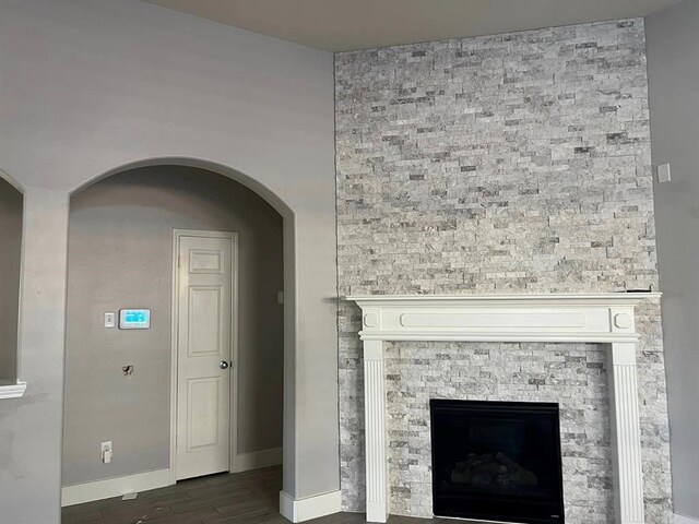 14538 Burleson Bend Dr, Houston, TX 77049 - details featuring arched walkways, a fireplace, baseboards, and wood finished floors