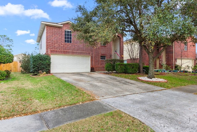 view of front of home featuring brick siding, fence, a front yard, a garage, and driveway