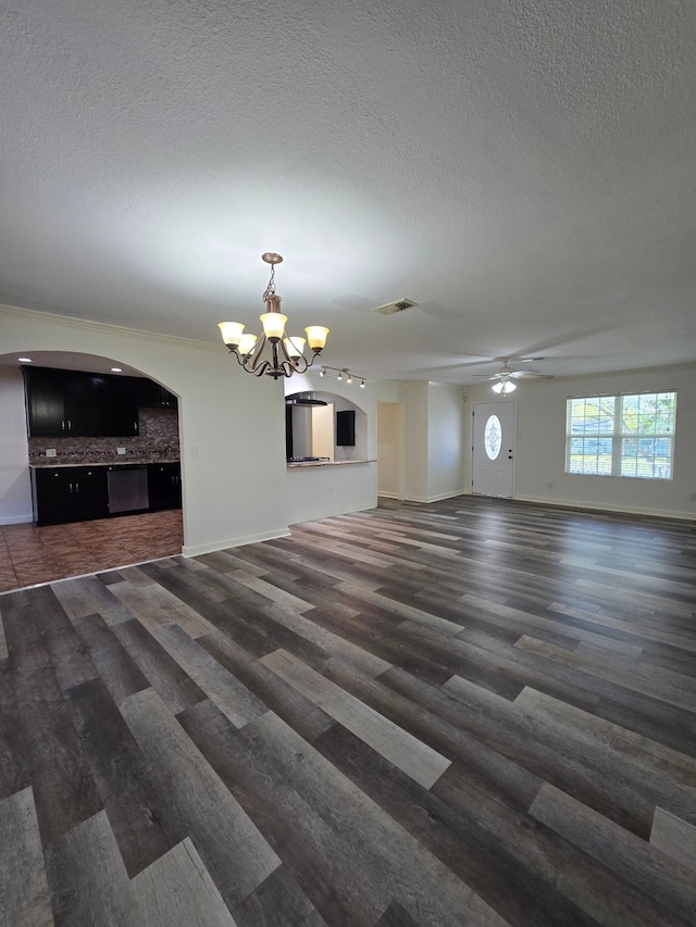 unfurnished living room featuring ceiling fan with notable chandelier, wood finished floors, a textured ceiling, and visible vents