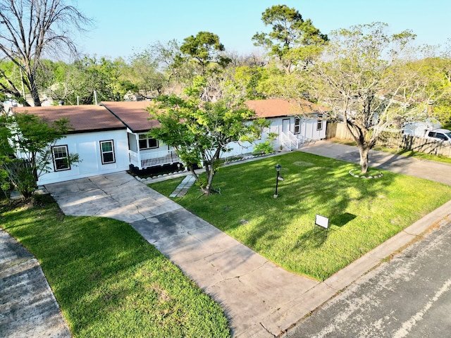 ranch-style house featuring a front lawn and concrete driveway