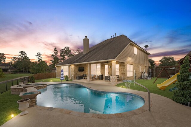 view of pool with a yard, a playground, a fenced backyard, and a patio area