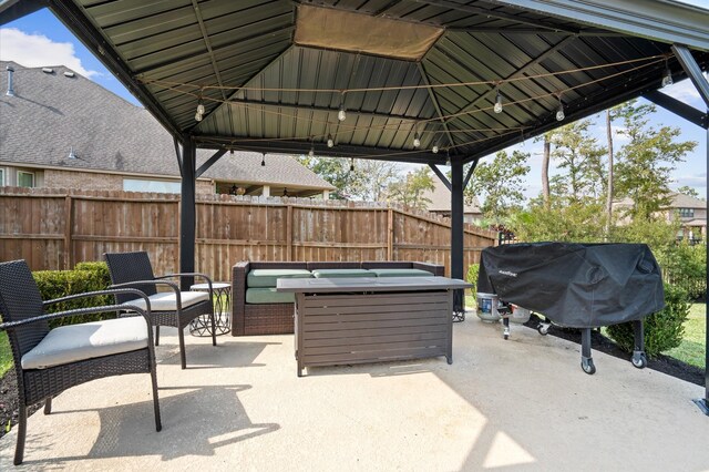 view of patio featuring fence, a gazebo, an outdoor hangout area, and area for grilling