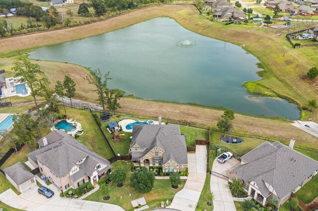 birds eye view of property featuring a water view and a residential view