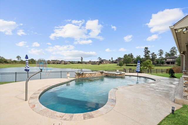 view of swimming pool featuring a patio, a lawn, fence, and a pool with connected hot tub