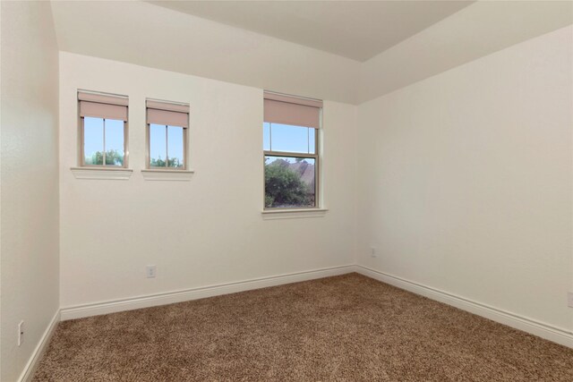 spare room with carpet floors and baseboards