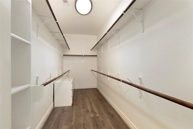 walk in closet featuring wood finished floors