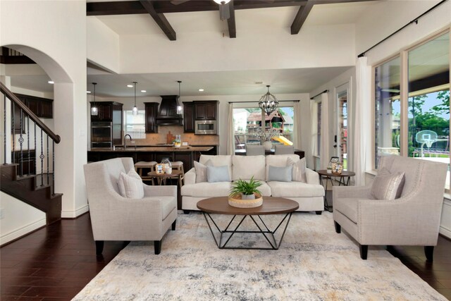 living area featuring recessed lighting, beamed ceiling, a healthy amount of sunlight, and hardwood / wood-style flooring