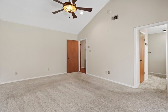 spare room with visible vents, high vaulted ceiling, carpet floors, baseboards, and ceiling fan