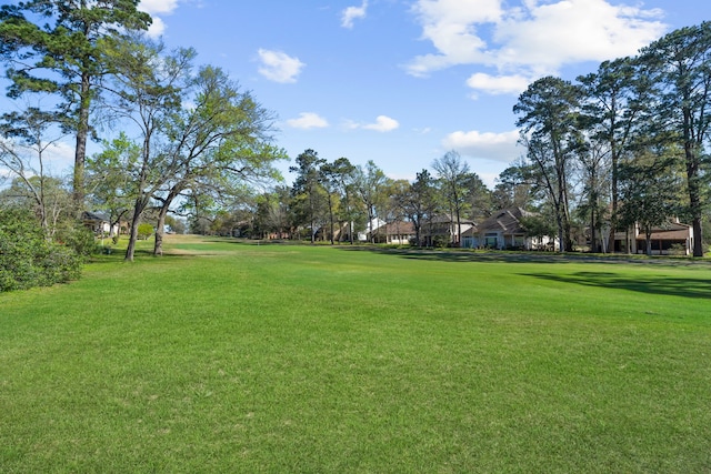 view of property's community with a lawn