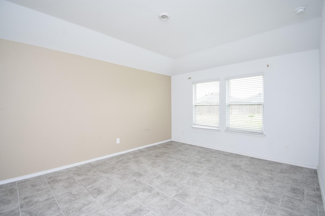 unfurnished room with baseboards