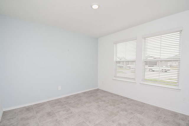 unfurnished room featuring baseboards