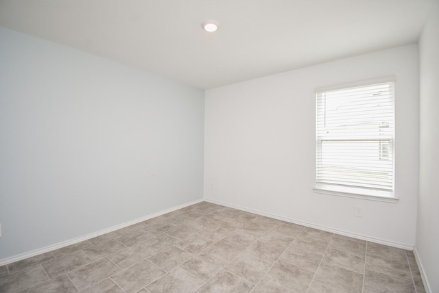 empty room featuring baseboards