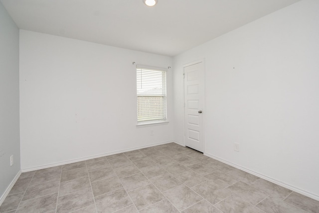 spare room with baseboards