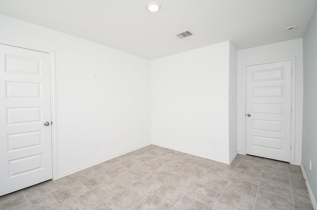 empty room with visible vents and baseboards