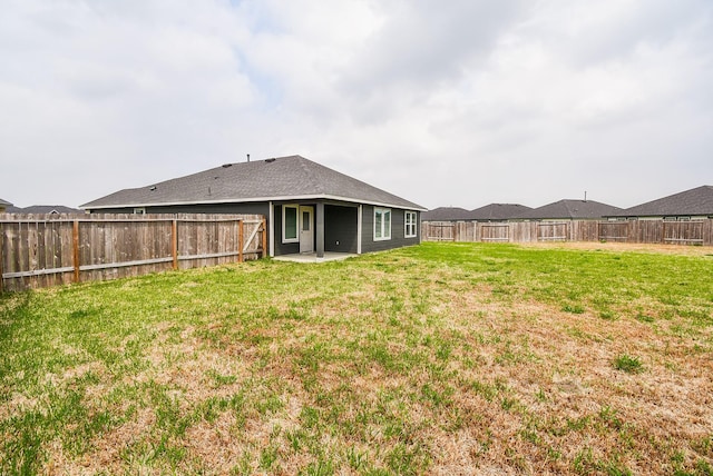 view of yard featuring a patio area and a fenced backyard