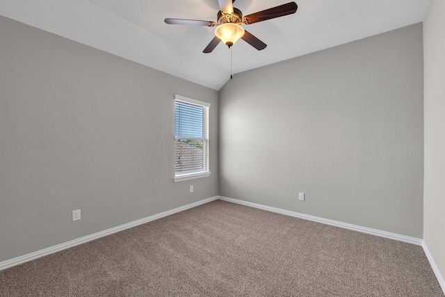 carpeted empty room with baseboards, lofted ceiling, and ceiling fan