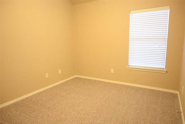 carpeted spare room with baseboards