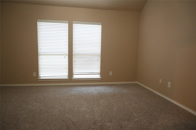 spare room featuring baseboards and carpet floors