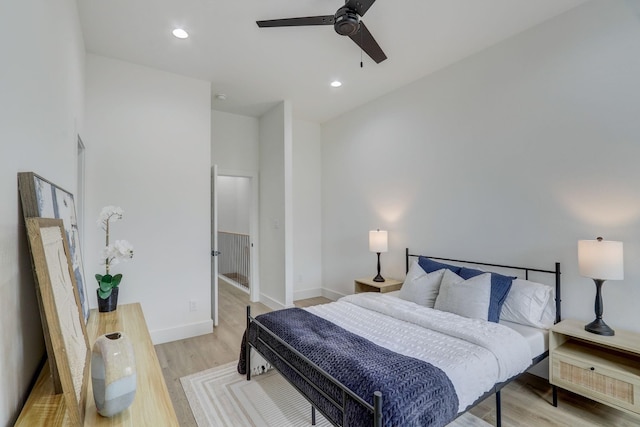 bedroom with recessed lighting, baseboards, light wood-style flooring, and a ceiling fan