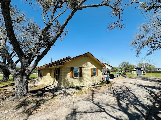 14431 Joyce St, Needville, TX 77461 - view of front of house with brick siding and an outdoor structure