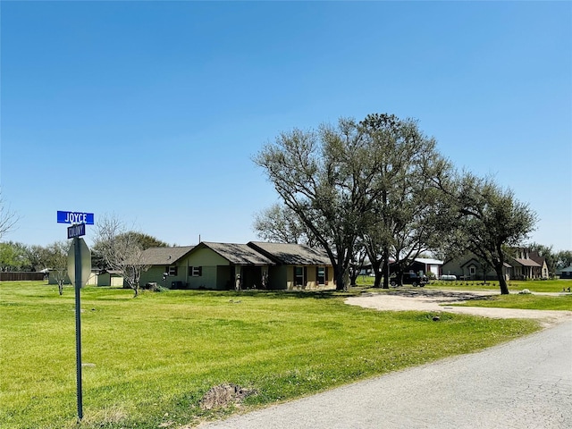 ranch-style house with driveway and a front yard