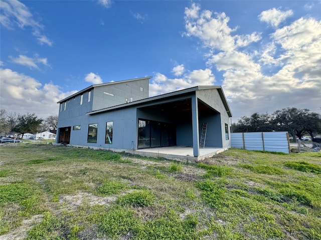 back of house featuring fence