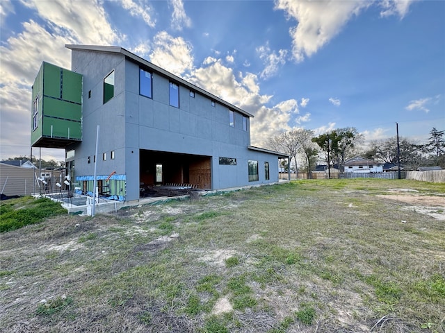 back of house featuring fence