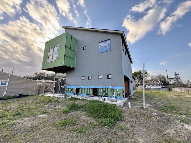 back of property featuring fence