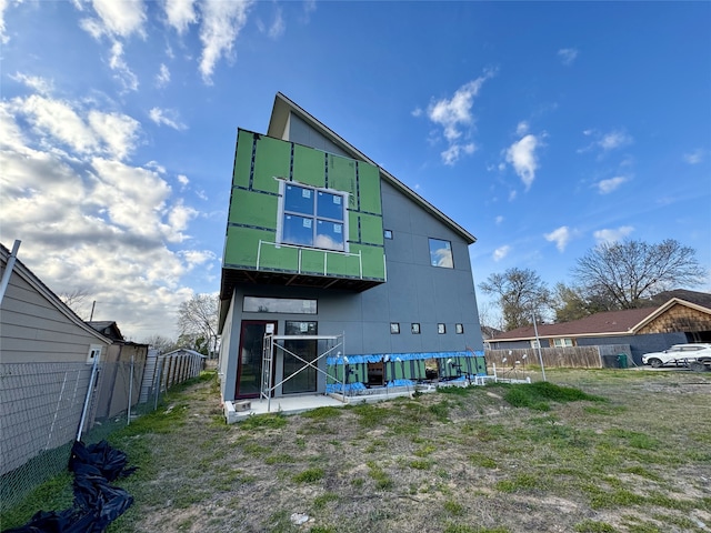 rear view of property with fence