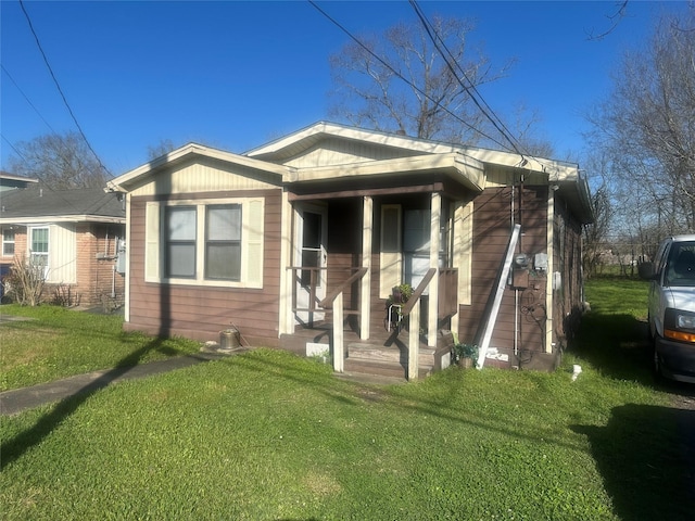 view of front of house with a front yard and covered porch