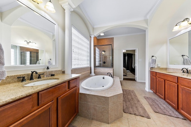 bathroom featuring crown molding, a sink, a garden tub, and a stall shower