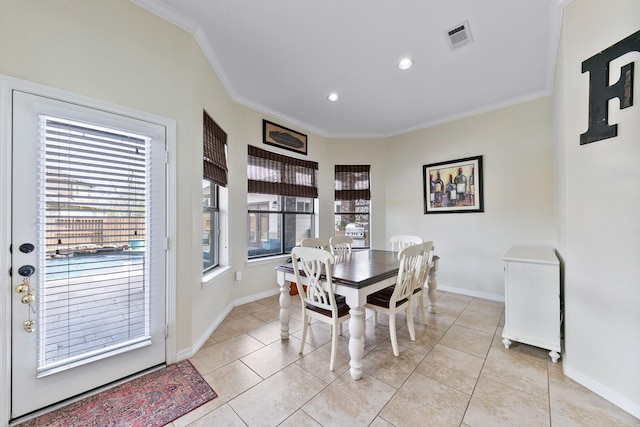 dining space featuring visible vents, baseboards, and crown molding