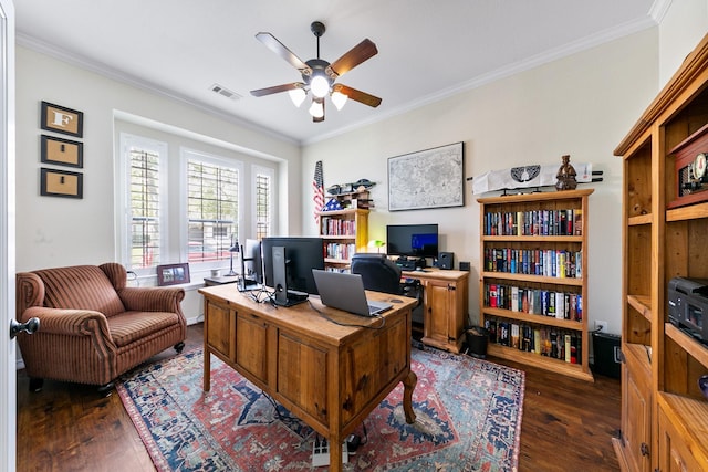 office space with crown molding, ceiling fan, dark wood-style flooring, and visible vents