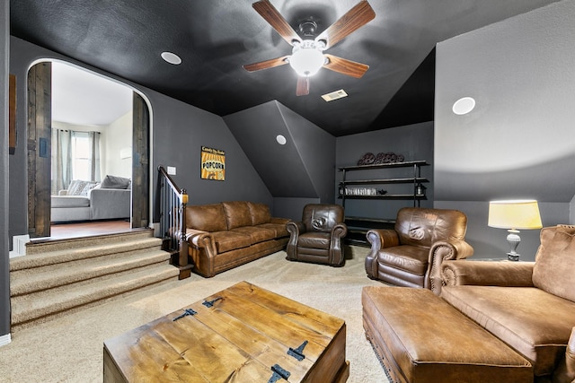 home theater featuring ceiling fan, carpet floors, arched walkways, lofted ceiling, and visible vents