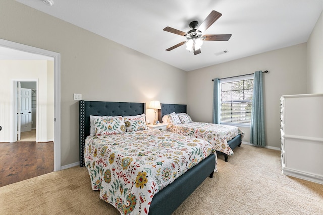 carpeted bedroom featuring visible vents, a ceiling fan, and baseboards