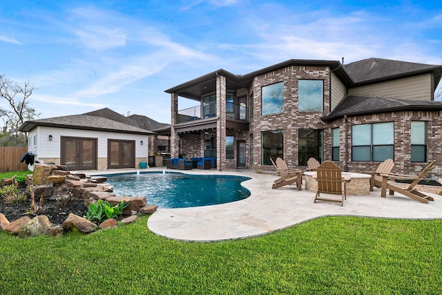 back of property with french doors, a lawn, a fenced in pool, a balcony, and a patio