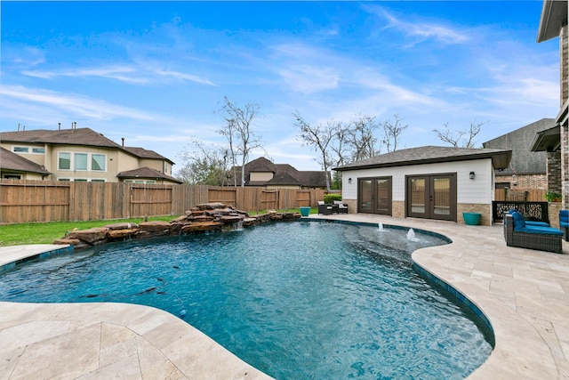 view of pool with french doors, a fenced in pool, a patio, and a fenced backyard