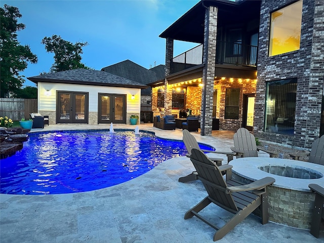 view of swimming pool with fence, a fenced in pool, an outbuilding, french doors, and a patio