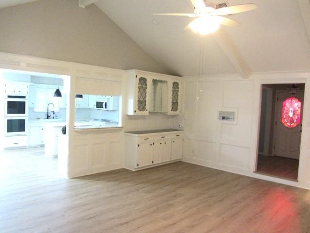 kitchen featuring white cabinetry, white appliances, and light wood-type flooring